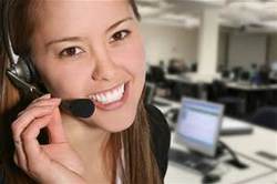 Woman smiling at the camera in a call center